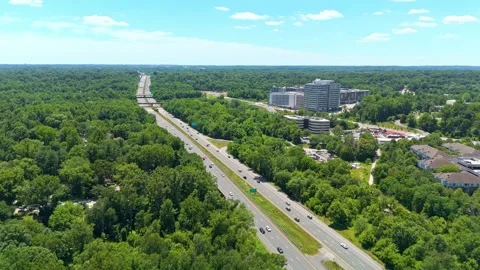 Wide Aerial View of Highway Surrounded by Trees Stock Footage 342761408