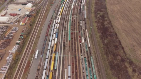 A wide aerial view of a large freight railway yard with numerous parallel Stock-Footage 321805188