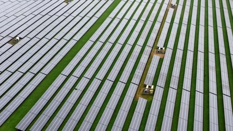 Wide aerial view of a massive commercial solar panel array situated across Video stock 340897976