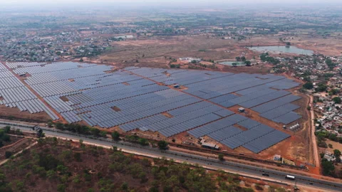 Wide Aerial View of Massive Solar Farm and Rural Landscape in India Stock Footage 334960035