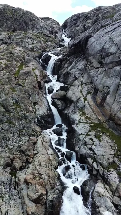 Wide aerial view of multi-tiered mountain waterfall and hiking trail cliff Stock Footage 336685415
