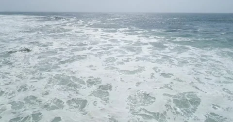Wide aerial view of ocean covered in white foam The Concept of natural power Stock Footage 336096819