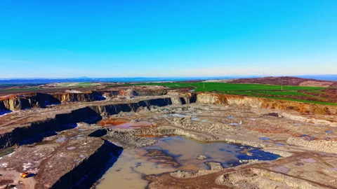 Wide aerial view of open pit stone quarry and machinery Video stock 333839240