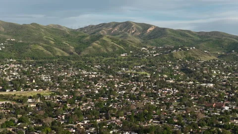 Wide aerial of Wasatch Mountain Range and Bountiful Utah homes in foothills Stock Footage 335724842