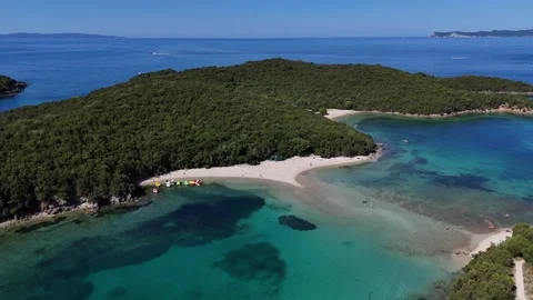 Wide angle 4K drone footage of Mourtemeno island and sandy beach bar in Sivota I Stock Footage 340566811