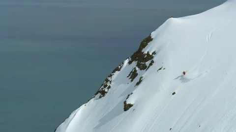 Wide angle aerial of freeride skier shredding big mountain in Iceland Stock Footage 124227409