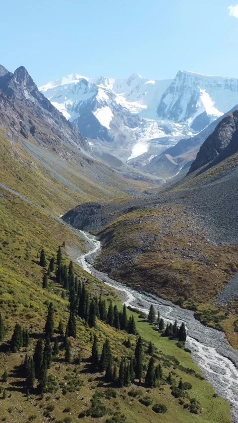 Wide angle aerial panorama of deep glacial valley with winding river Stock Footage 336689189