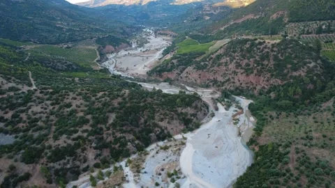 Wide angle aerial shot of a white river and green vineyards Stock Footage 343962076
