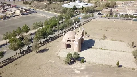 Wide-angle aerial view of a historic Persian mausoleum situated in a dry open Video stock 307793365