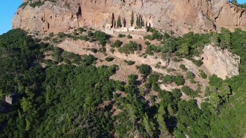 Wide angle aerial view of a historic orthodox chapel on a rocky precipice Stock Footage 343961343