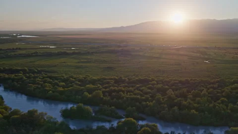 Wide-Angle Aerial View of Sunset over Zhaosu Wetland Park and Tekes River Video stock 342391088