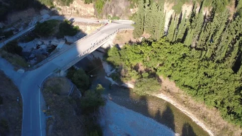 Wide angle aerial view of an uphill highway bridge in a dense forest Stock Footage 343961371