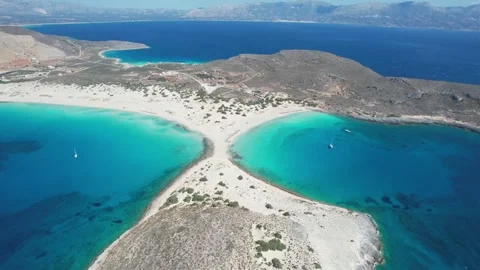 Wide angle aerial view of Voidokilia double beach with anchored yachts Stock Footage 337046356