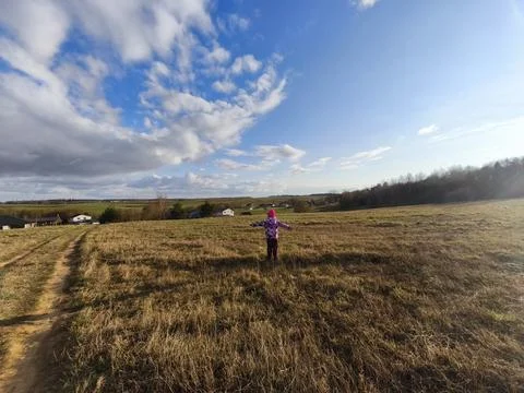 Wide Angle Back View of Little Girl on Scenic Countryside Hill Stock Photos