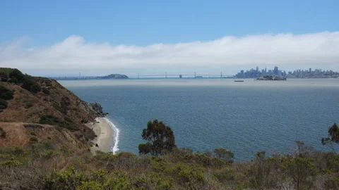 Wide angle bay bridge from angel island fog sun beach Video stock 136433228