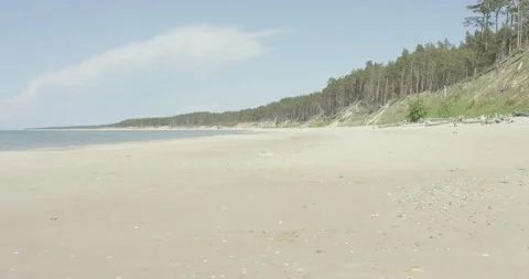 Wide angle beach scene with white sand and small waves in sunny summer day Stock Footage 159982858