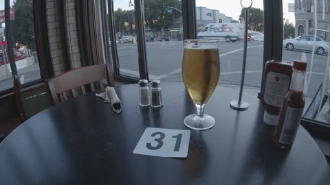 Wide Angle of Beer, patiently waiting on food at restaurant Stock Footage 101437528
