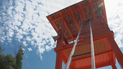 Wide angle bottom view on high rescue box with ladder on the beach on the cloudu Stockbeeldmateriaal 109112937