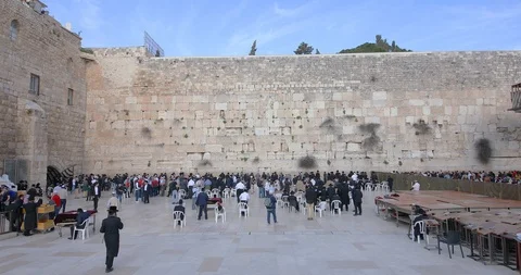Wide angle camera moved along Western Wall from the entrance to synagogue Stock Footage 105075271