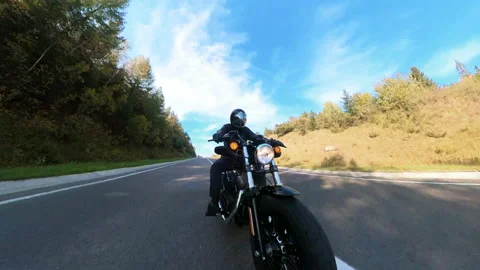 Wide-angle camera view of motorcyclist riding on black bike outdoors. Lonely Stock-Footage 167923157