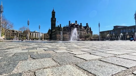 Wide-angle cinematic view of City Hall clock tower and fountains in Bradford Stock Footage 334995602