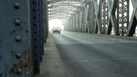 Wide angle clip of cars passing on the asphalt road through the bridge tunnel Stock Footage