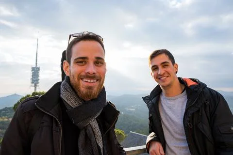 Wide angle close-up view of two engineers at a power plant smiling at the cam Foto stock