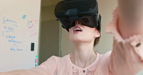 Wide angle close up of a woman using Virtual Reality Headset standing in front Stock Footage 137273020
