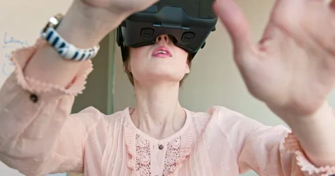 Wide angle close up of a woman using Virtual Reality Headset standing in front Stock Footage 137273468