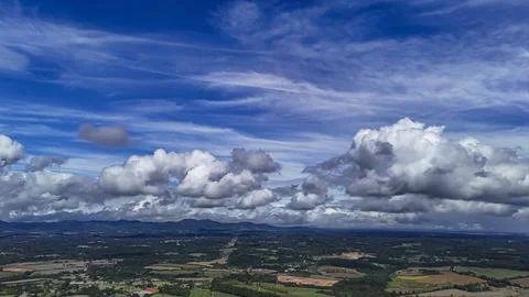 A wide-angle composition that highlights the contrast between a dynamic, clou Fotos Stock