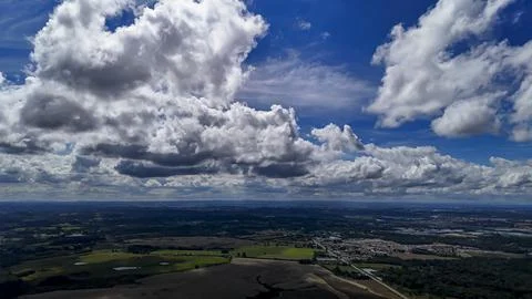 A wide-angle composition that highlights the contrast between a dynamic, clou Foto stock