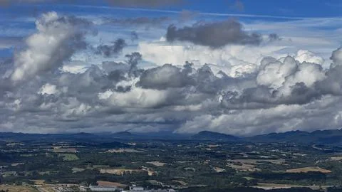 A wide-angle composition that highlights the contrast between a dynamic, clou Stock Photos