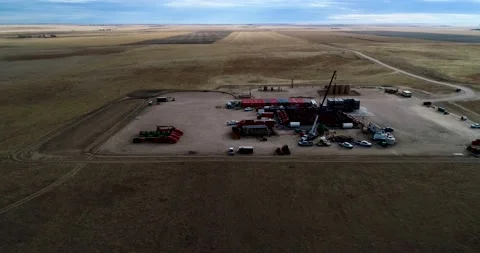 Wide angle dramatic lighting of a fracking oil extraction pad 2021 in Stock Footage 167396494