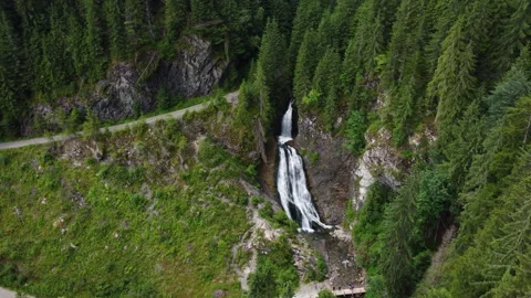 Wide angle drone shot above the forest and Bride's Veil waterfall in Transylvani Stock Footage 307431355