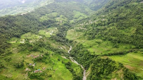 Wide Angle drone view of a village in the Himalayas of Nepal with rice terraces Vídeo Stock 134581756