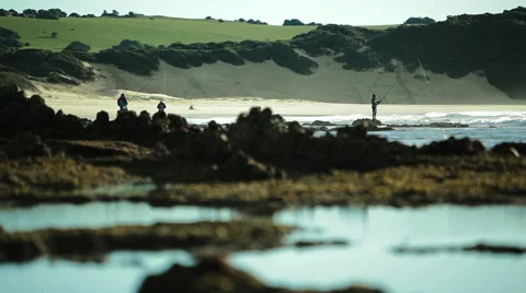 Wide angle of a fisherman casting out to sea Stock Footage 48339519