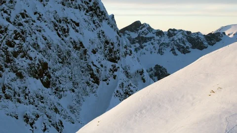 Wide angle of freeride skier enjoying skiing down big mountain in Swiss Alps Stock Footage 129083547