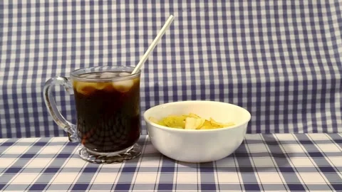 Wide angle front view coke served in a glass cup with ice, straw liquor, an.. 動画素材 318127805