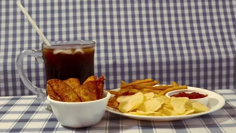 Wide angle front view crispy fried french fries, chips, and ketchup on a pl.. Video stock 318127680