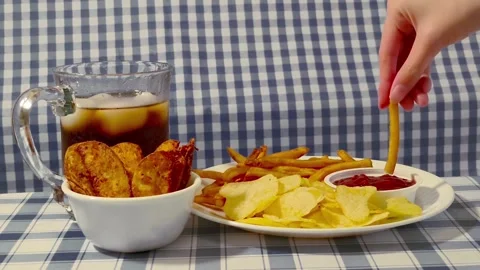 Wide angle front view of dipping crispy fried french fries on a plate dish .. 動画素材 318127639