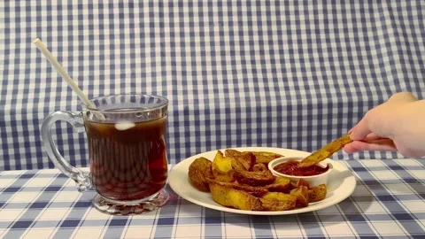 Wide angle front view of dipping crispy fried potato wedges in ketchup on a.. Video stock 318127646