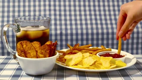 Wide angle front view dipping ketchup on plate of crispy fried french fries.. Video stock 318127682