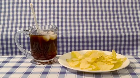 Wide angle front view of putting straw in a glass cup with coke and ice. Pl.. Video stock 318127637