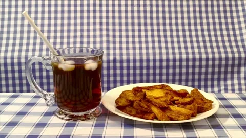 Wide angle front view of a putting a straw in a glass cup of coke with ice .. Video stock 318127647