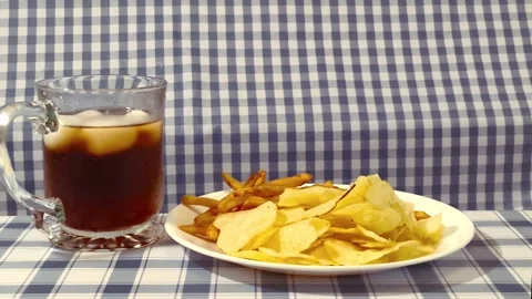 Wide angle front view of yellow golden potato chips and cripsy french fries.. Video stock 318127687