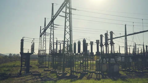 Wide angle, high voltage substation with tall pylons and voltage distribution  Stock Footage 142591328