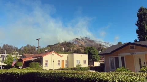 Wide angle of a hill fire near communications tower - 4KUHD Stock Footage 344516632
