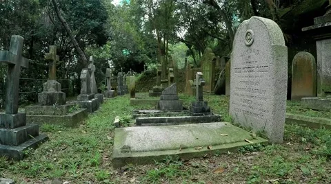 Wide angle lens camera moving through gravestones at the old christian cemetry. Stock Footage 64905625