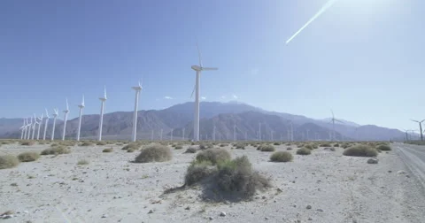 Wide angle lens panning through sun flare at wind farm 4K Stock Footage 63845722