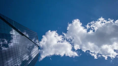 Wide angle looking up time-lapse financial district glass skyscrapers blue sky Stock Footage 337647489